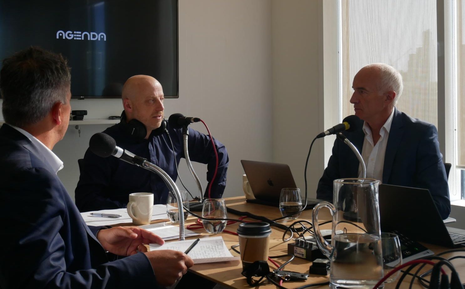 Oxera Podcast recording session. People around a table.